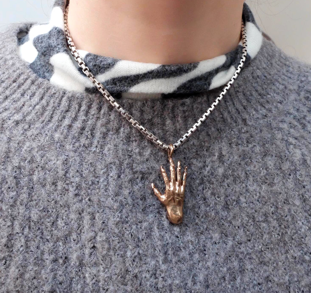 Hand of glory charm, bronze