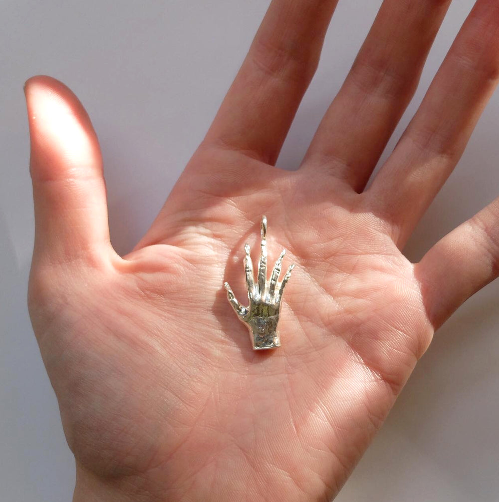 Hand of glory charm, bronze