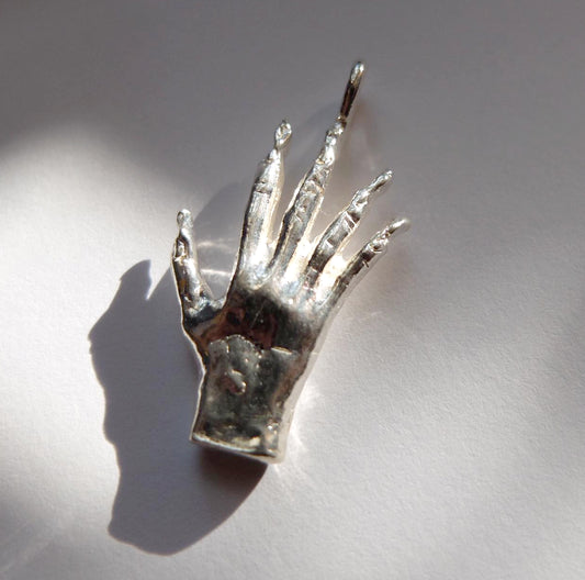 Hand of glory charm, bronze
